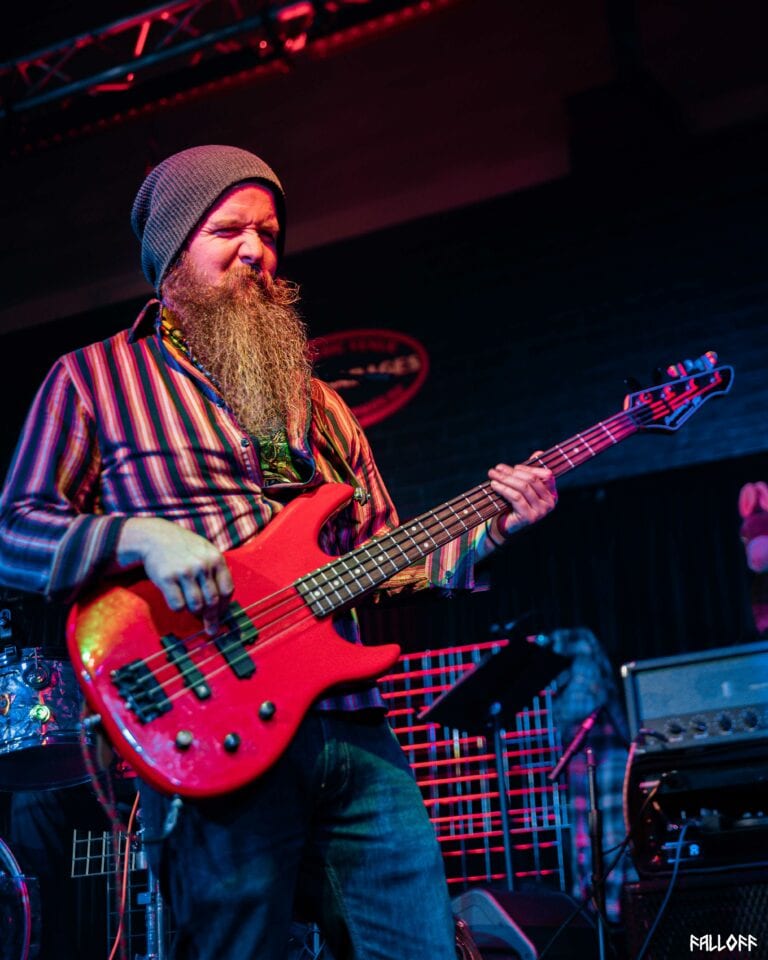 Picture of Taylor on stage 'getting into it' with a grimace on his face.